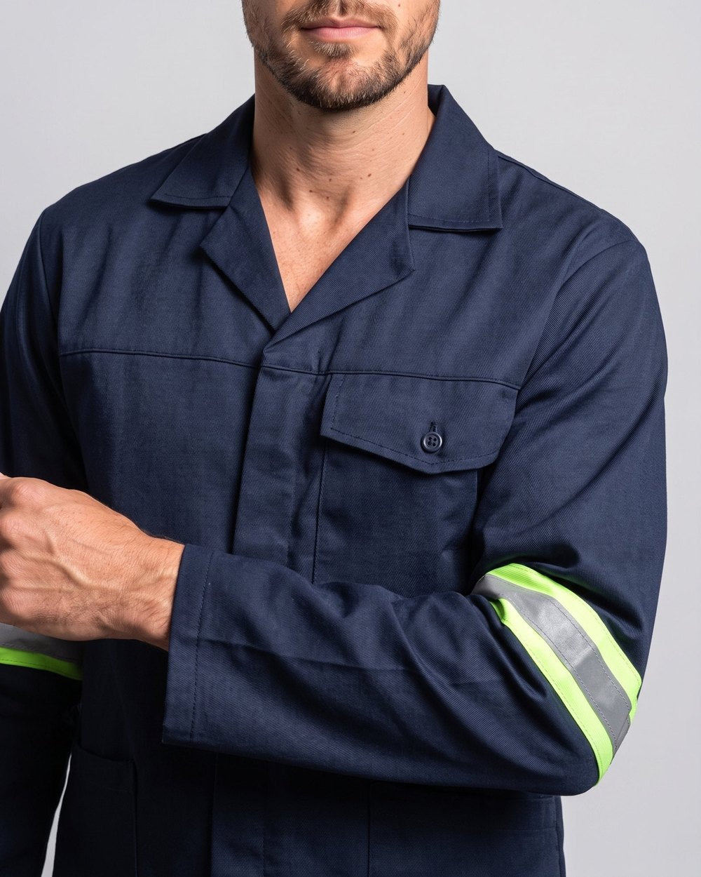 Close-up of the chest pocket and reflective sleeve tape on a navy Teesav conti jacket